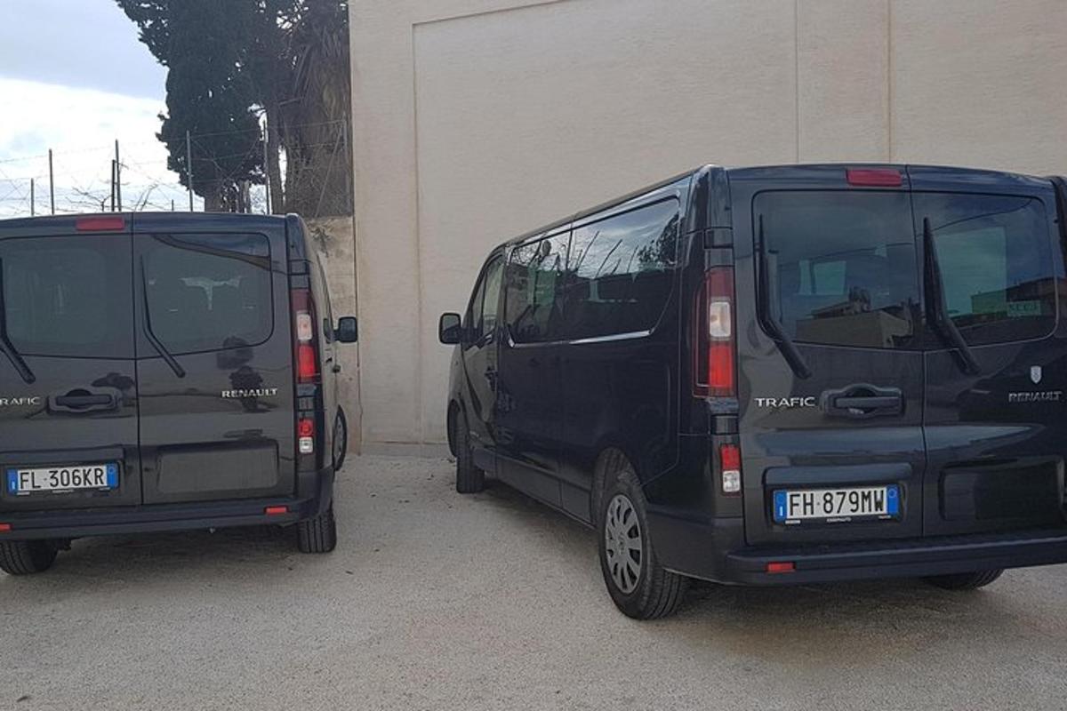 two black vans parked next to a building