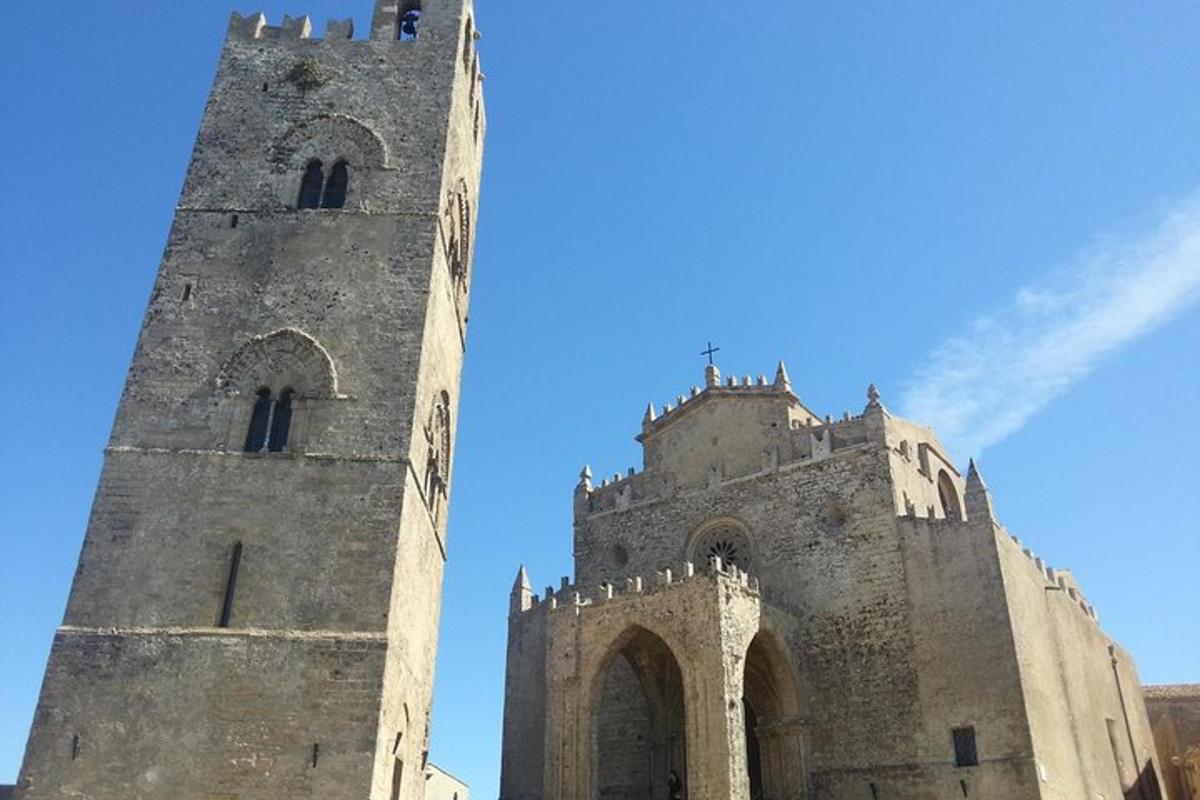 two towers of a castle with the sky in the background