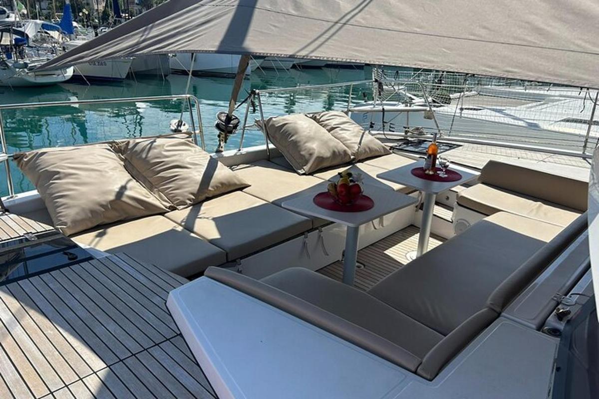 a boat with two pillows and a table on the deck
