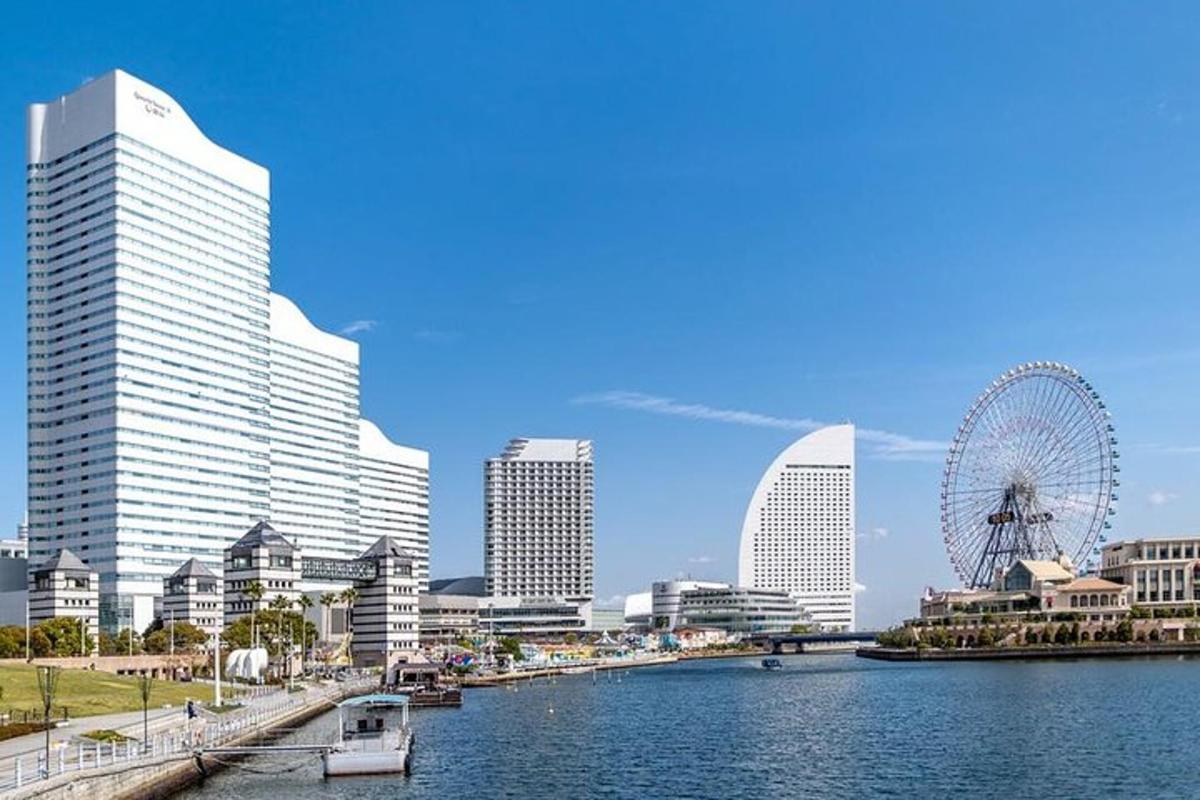 a city with a ferris wheel and a river with buildings