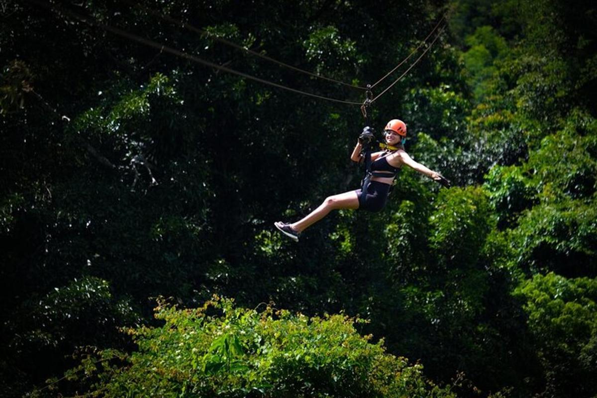 a woman flying through the air on a zip line