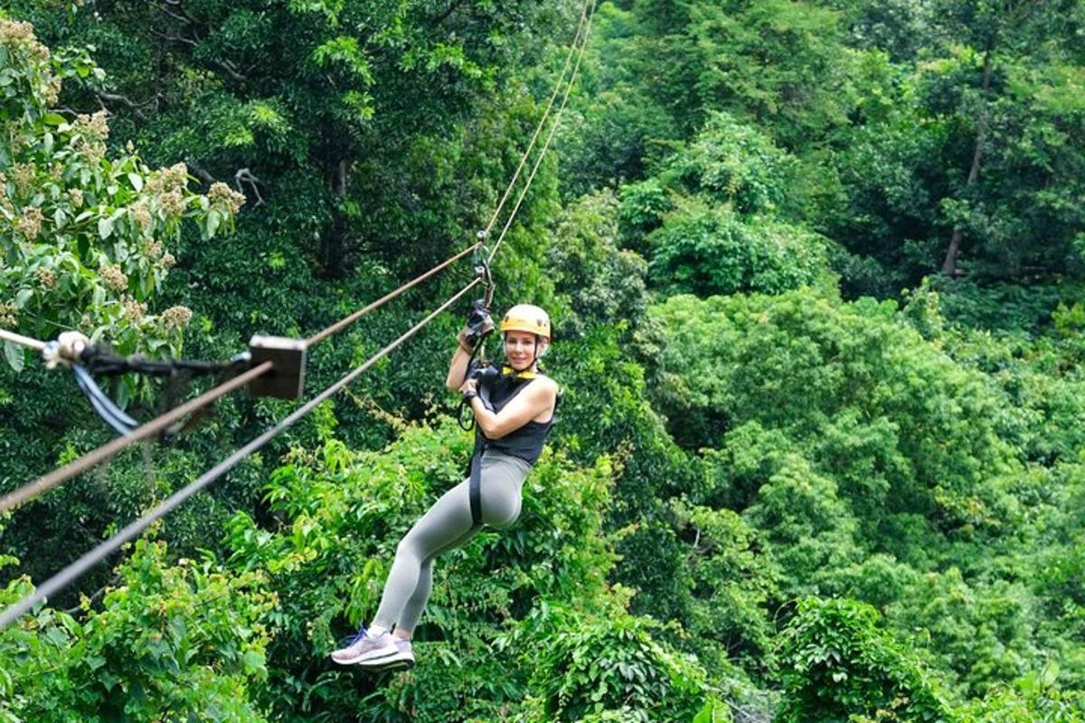 a woman on a zip line in the forest