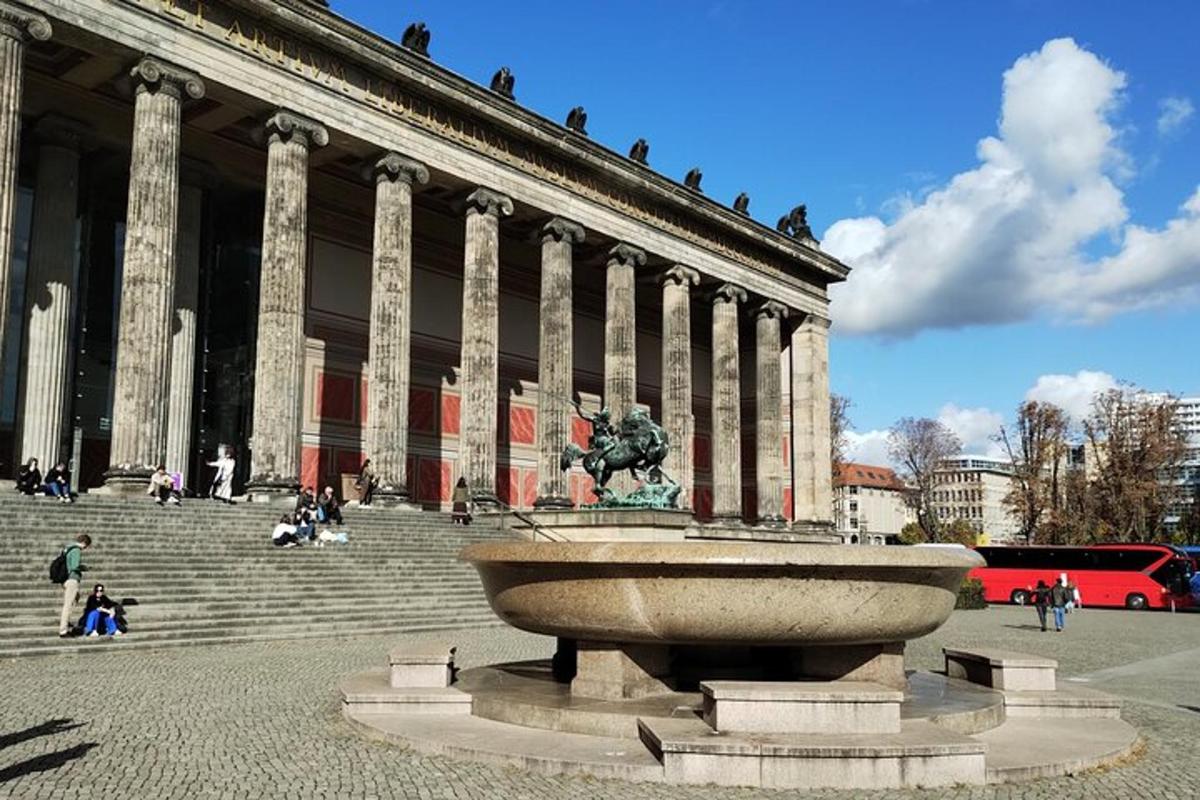 a large building with a statue in front of a fountain