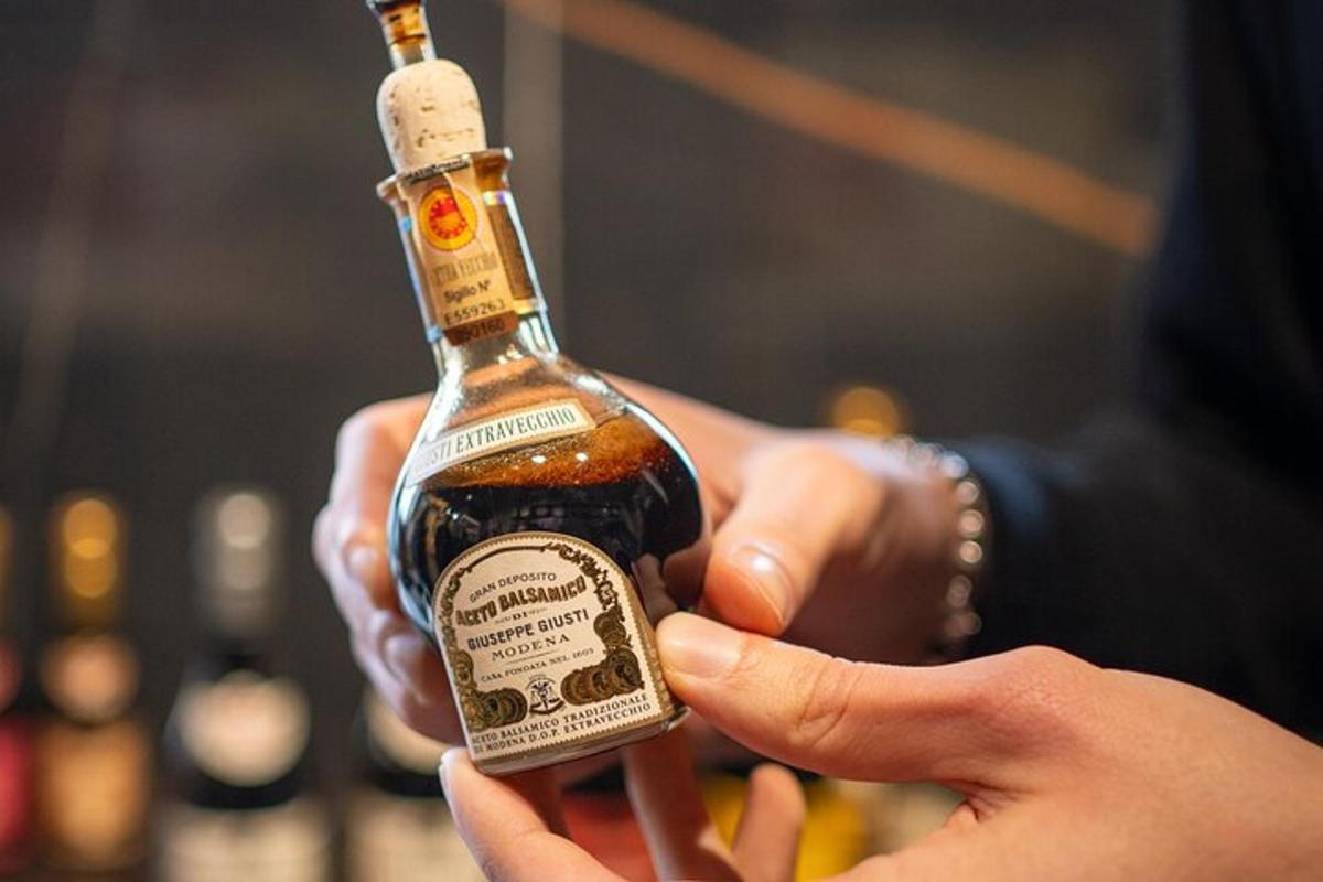a person is holding a bottle of alcohol