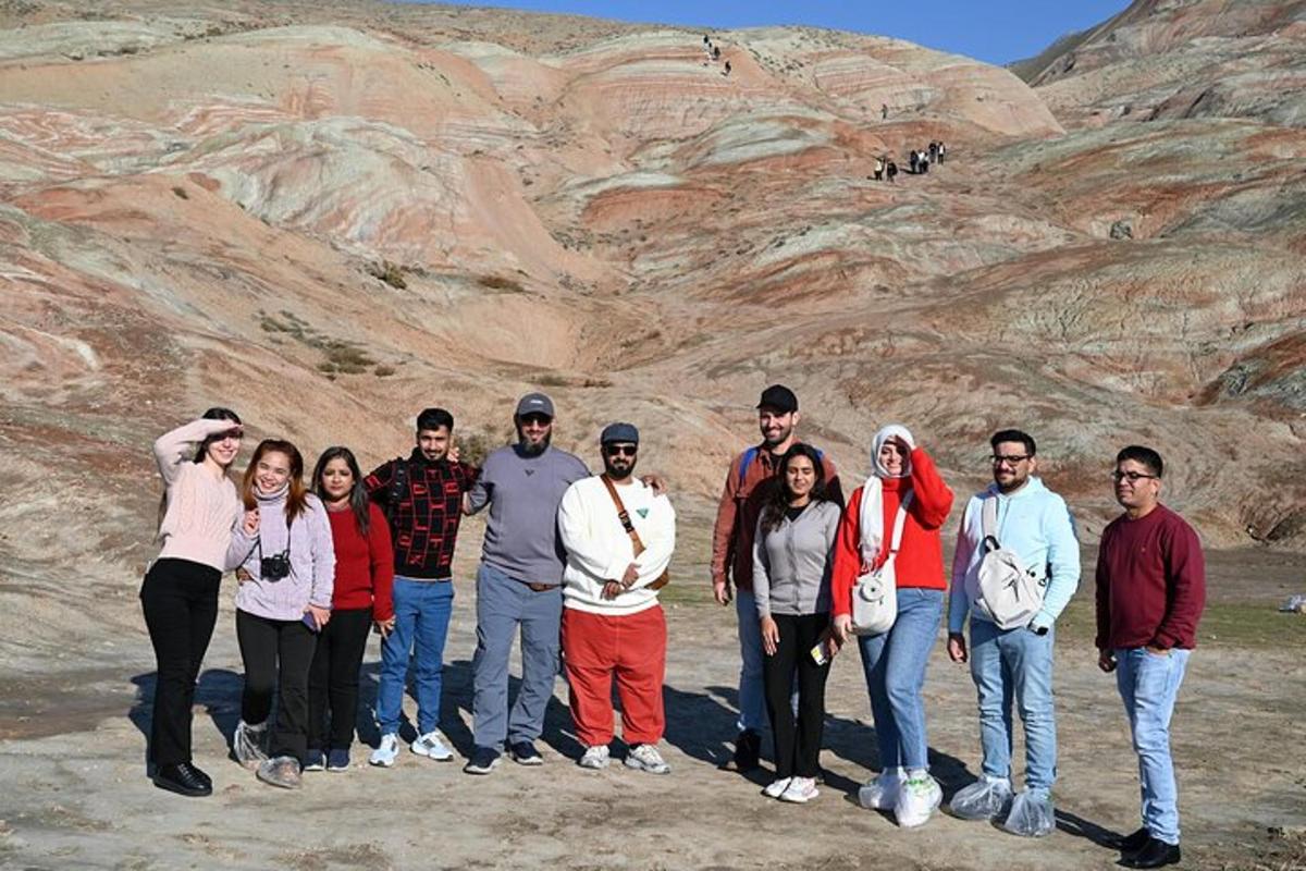 a group of people standing in front of a mountain