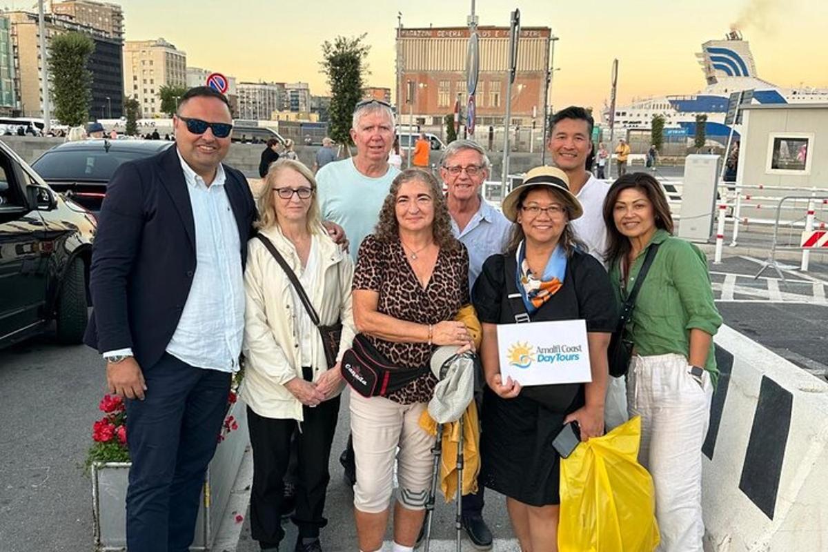 a group of people posing for a picture in a parking lot