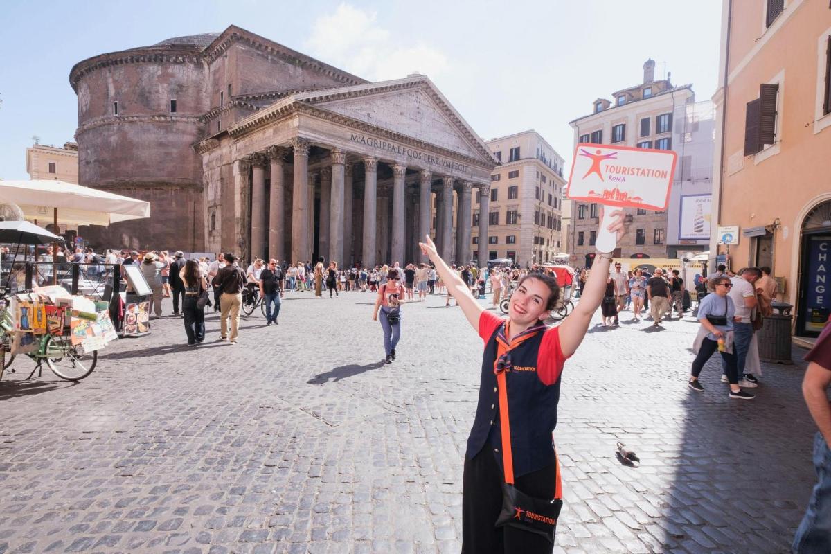 a woman holding up a sign in front of a building