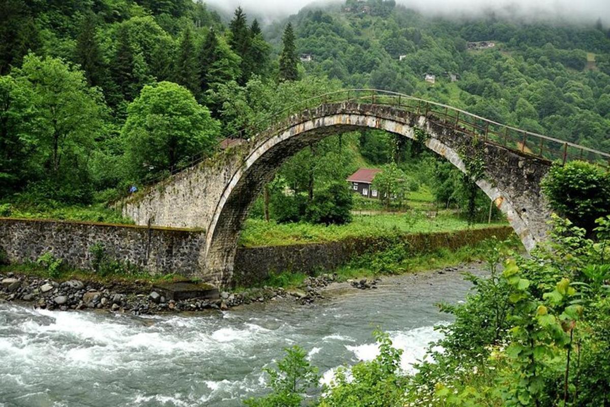 an old stone bridge over a river