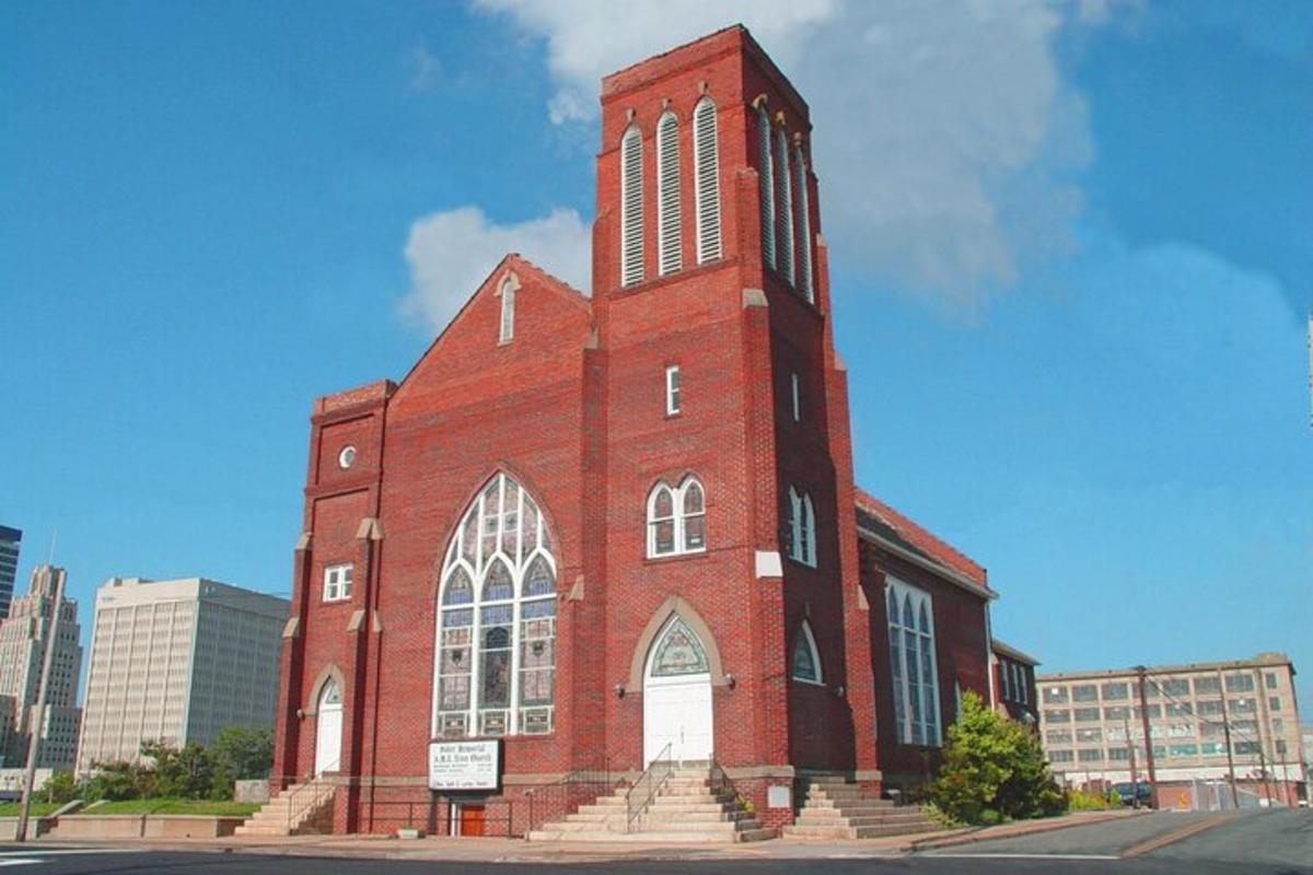 a large red brick building with a clock tower