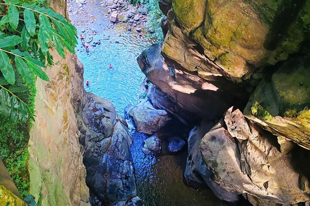 an aerial view of a river between some rocks