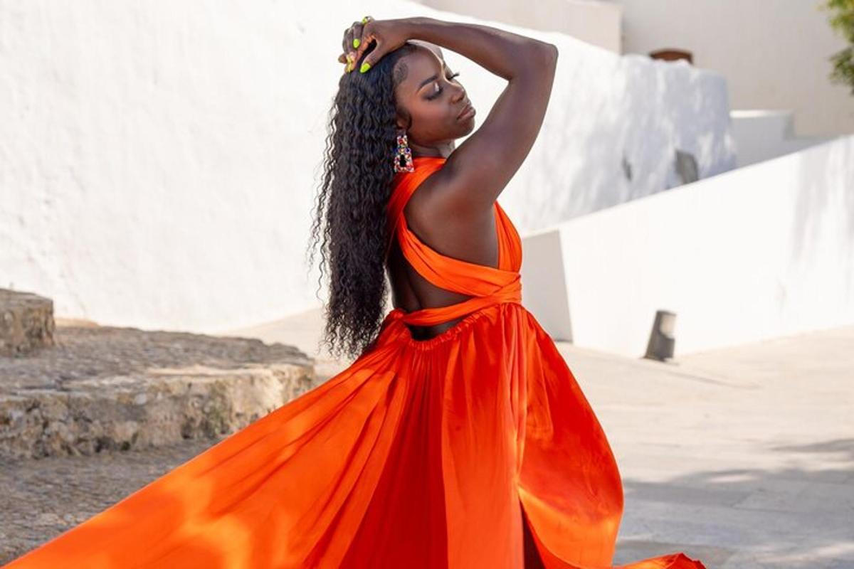 a woman in an orange dress with herraid