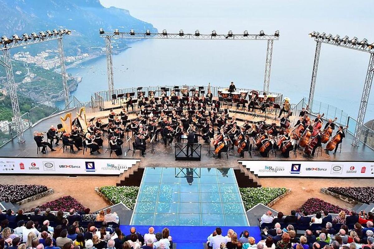 a large group of people on a stage with a orchestra