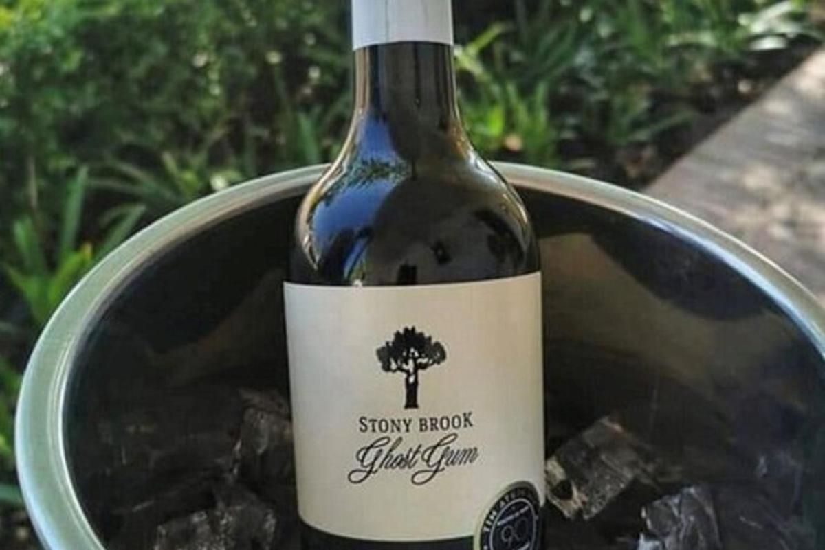 a bottle of wine sitting in a bucket