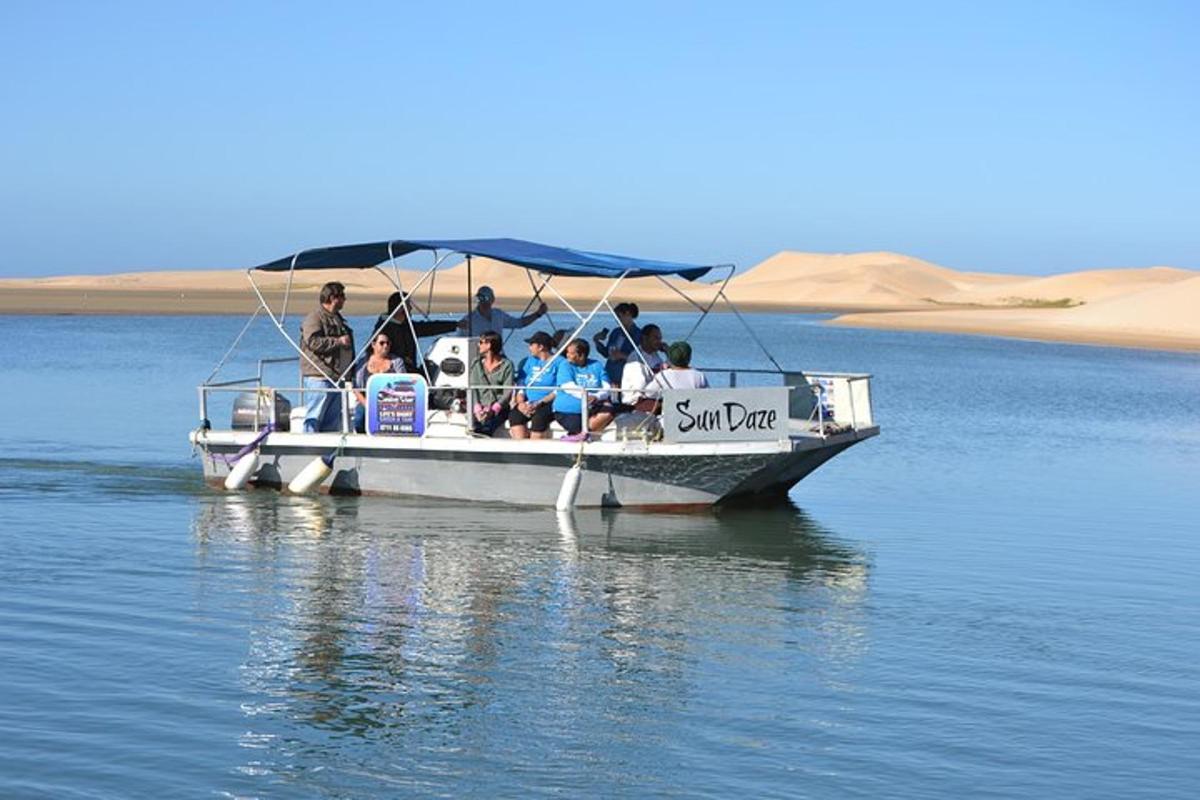 a group of people sitting on a boat on the water