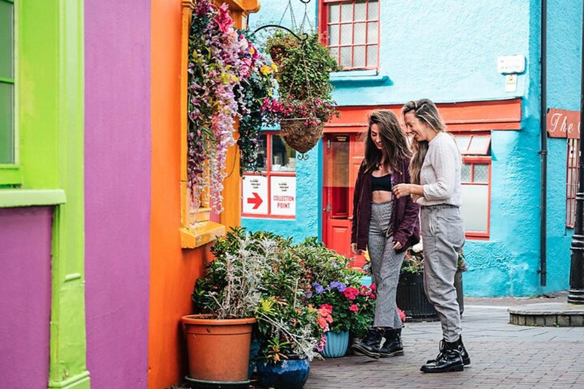 two people standing in front of a colorful building