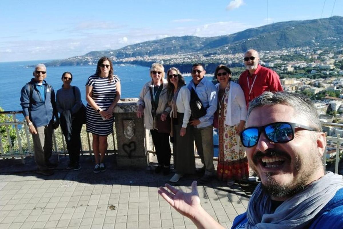 a group of people posing for a picture on a ledge