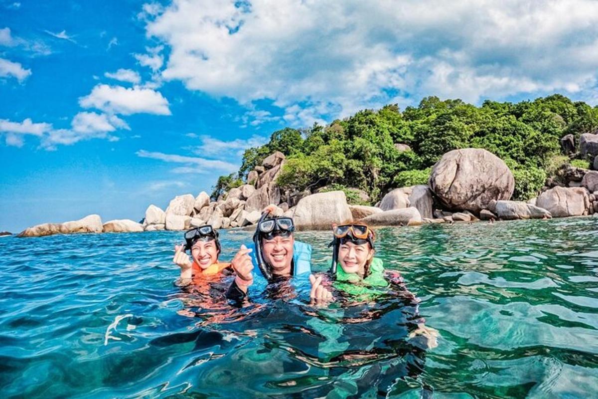 three people in the water in the ocean