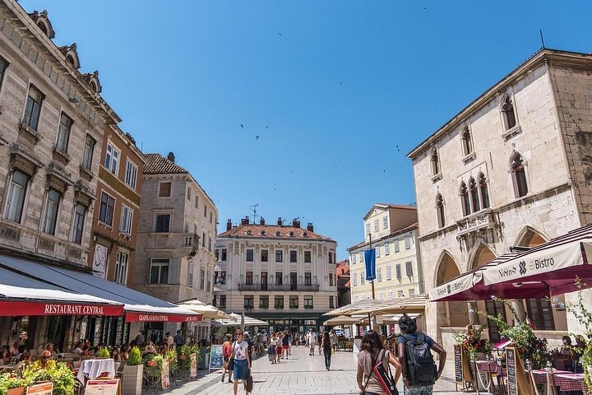 a group of people walking down a city street