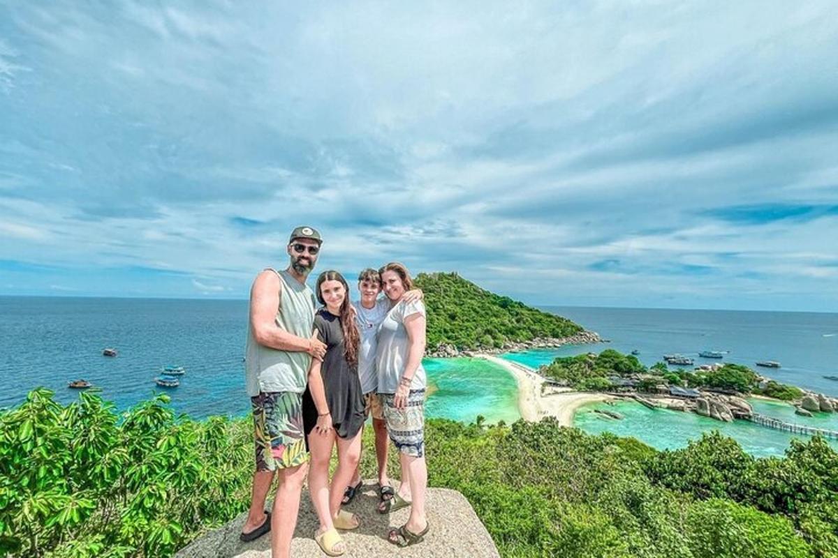 a group of people standing on top of a mountain