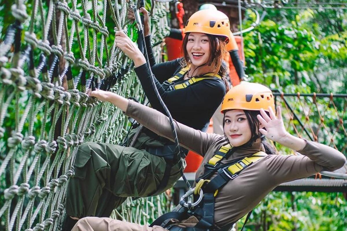 two women in hard hats on a rope bridge