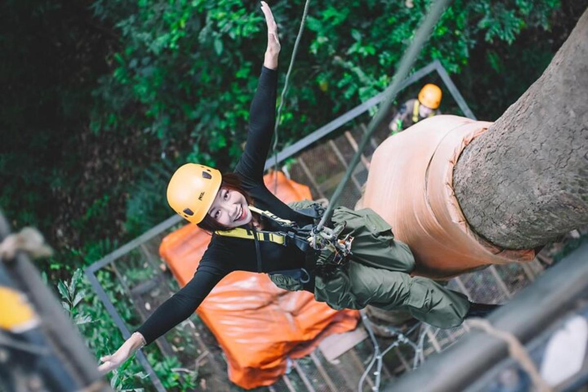 a woman in a helmet on a zip line