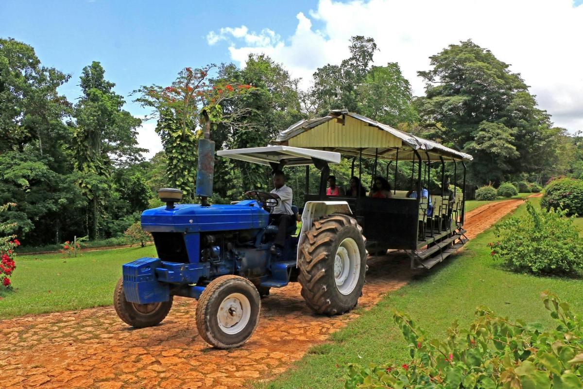 a blue tractor pulling a cart with people in it