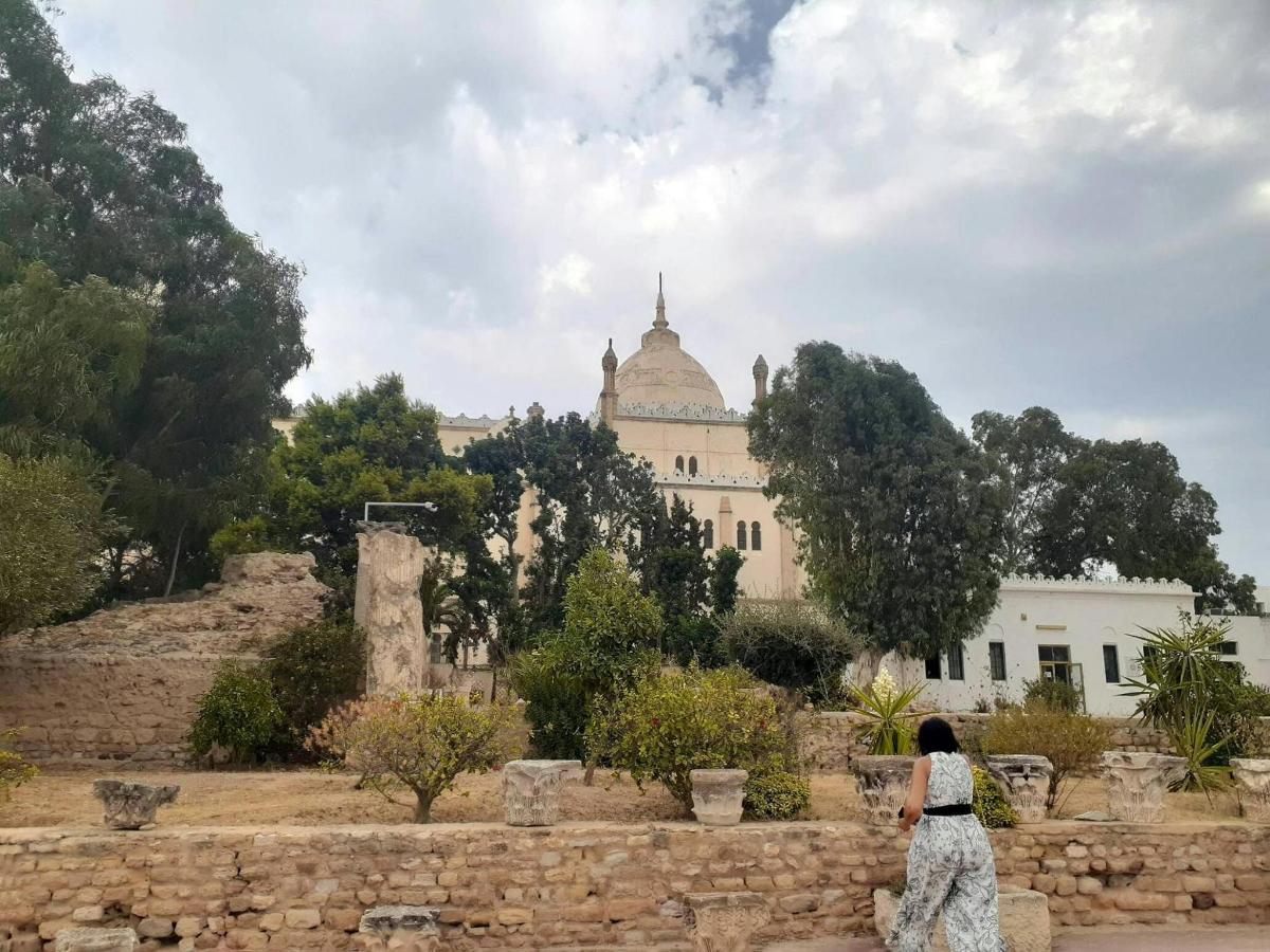 a woman standing on a wall looking at a building