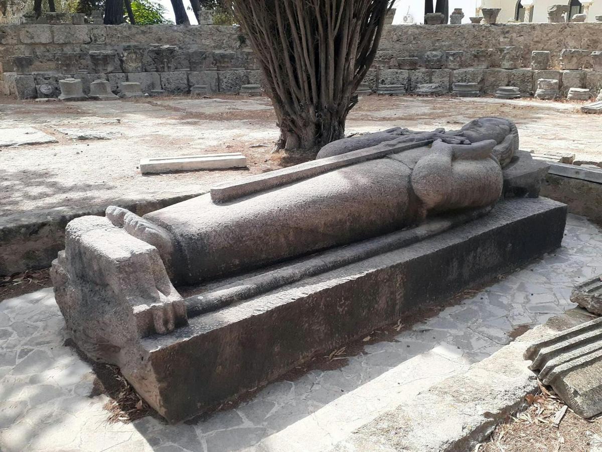 a statue of a person sitting on a bench