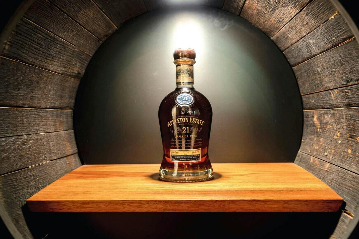 a bottle of whiskey sitting on a wooden shelf