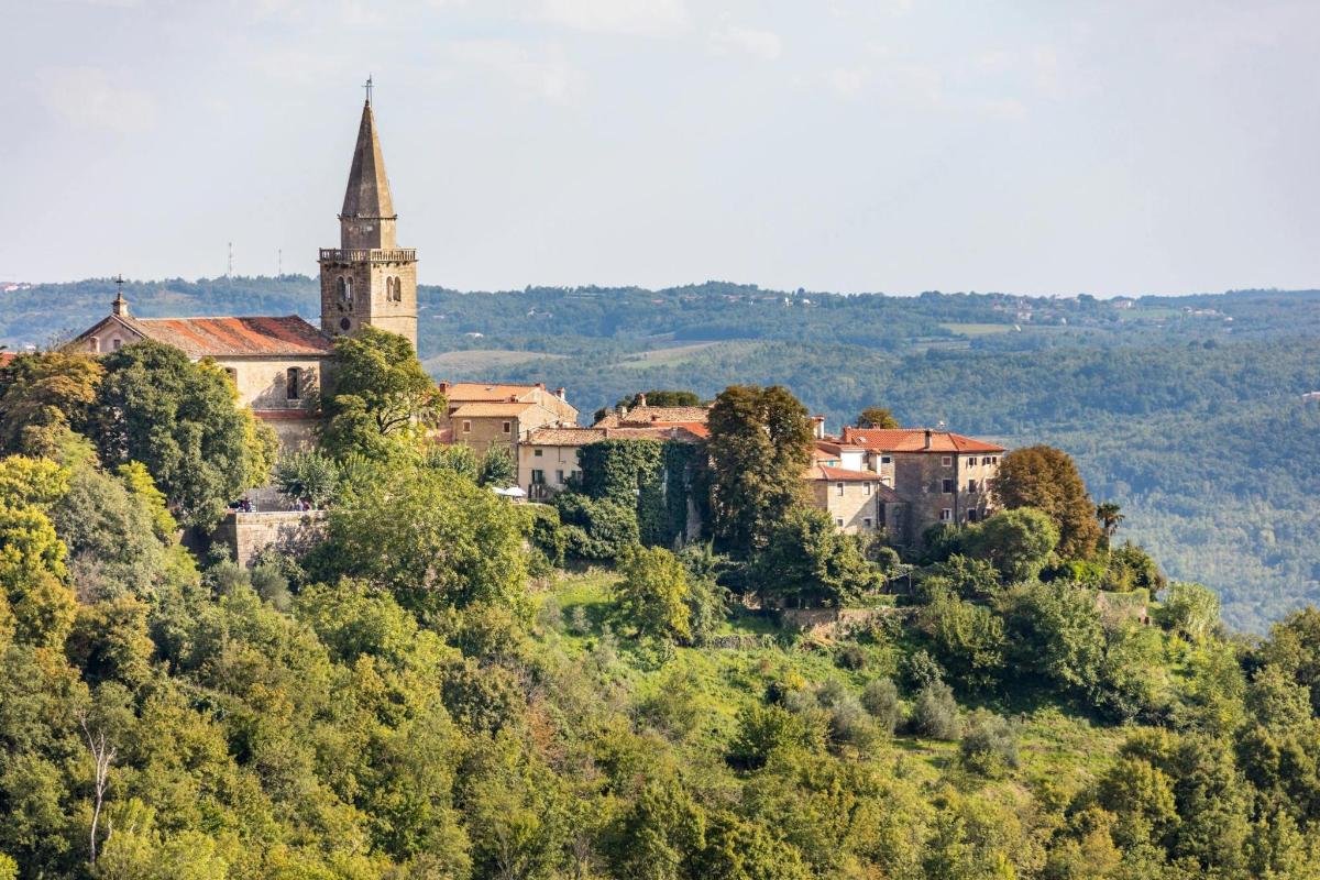 a town on top of a hill with a church