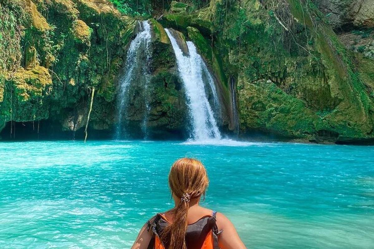 una donna è seduta davanti a una cascata