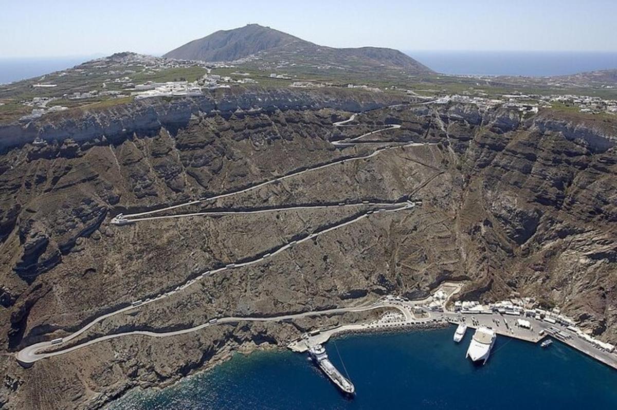 an aerial view of a mountain with a body of water
