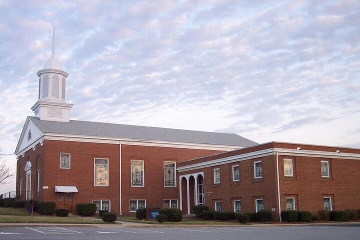 a large red brick building with a white tower