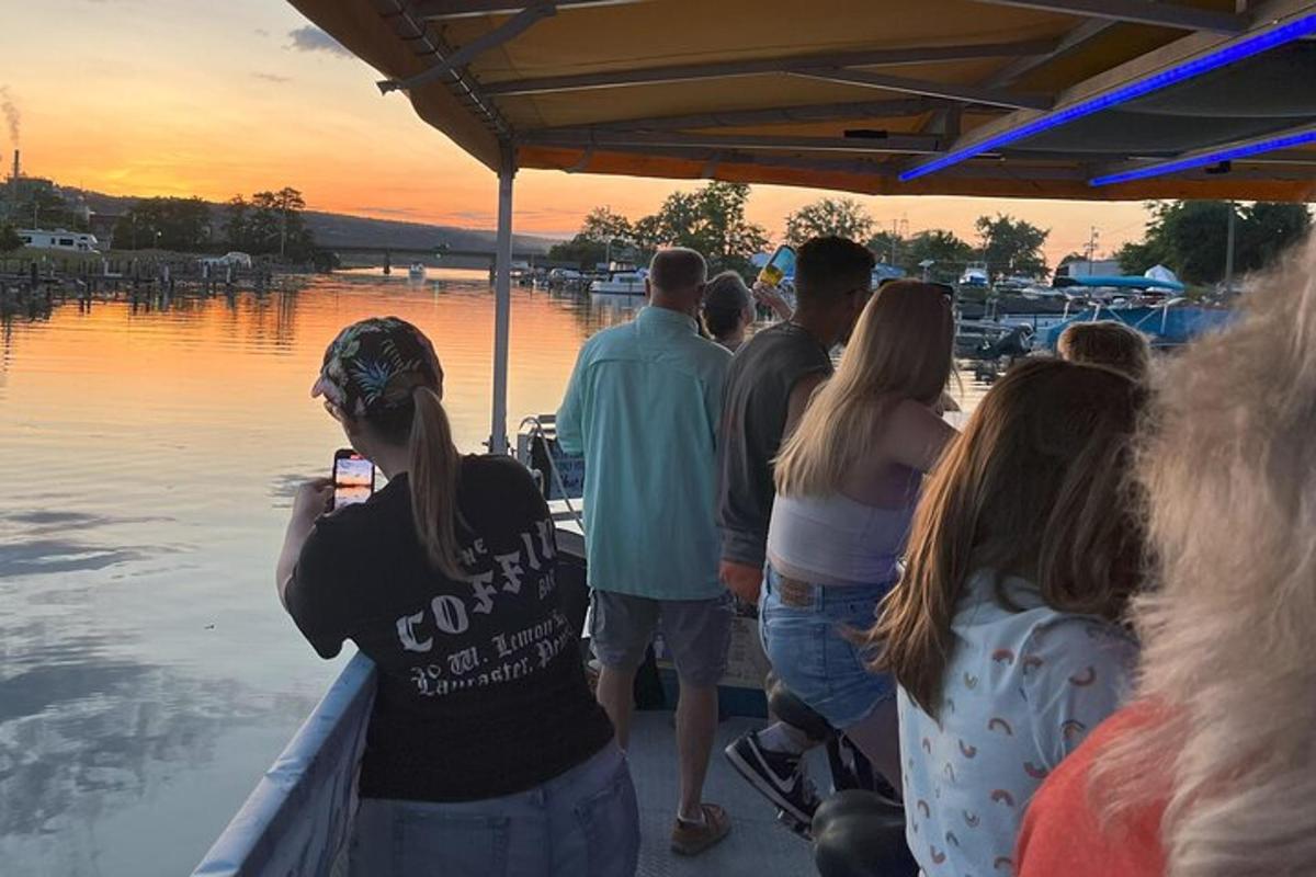a group of people standing on a boat looking at the water