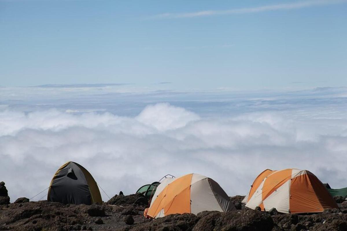 three tents sitting on top of a pile of rocks