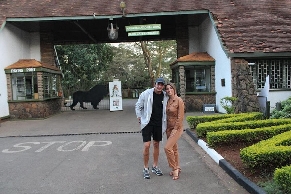a man and a woman standing in front of a building