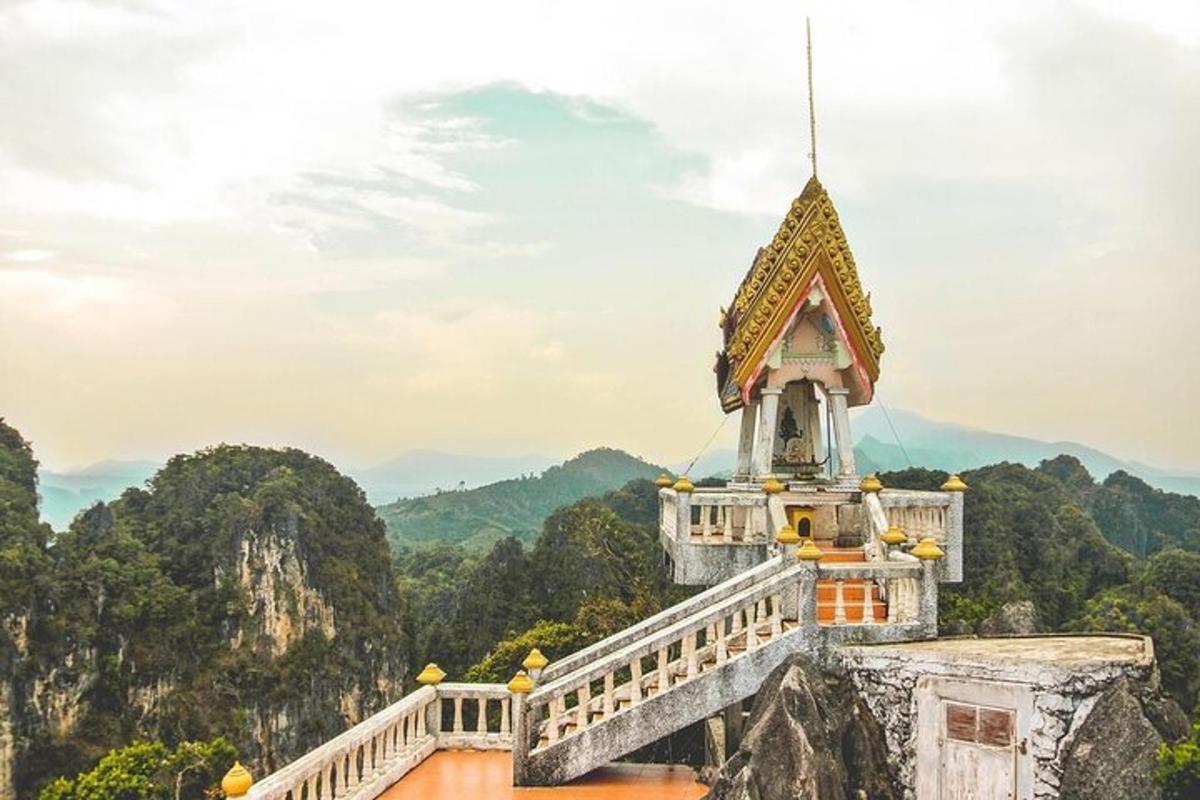 a building on top of a mountain with mountains in the background