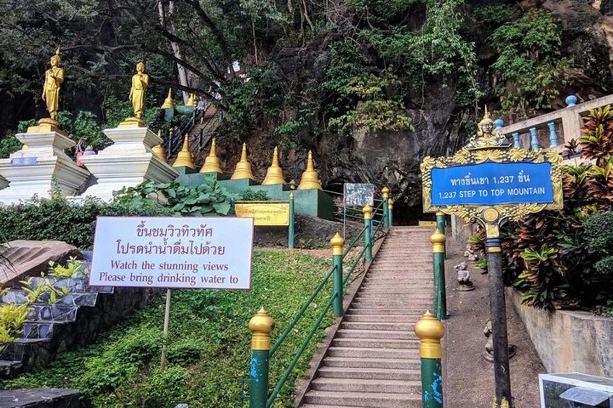 a stairway leading to a temple with statues
