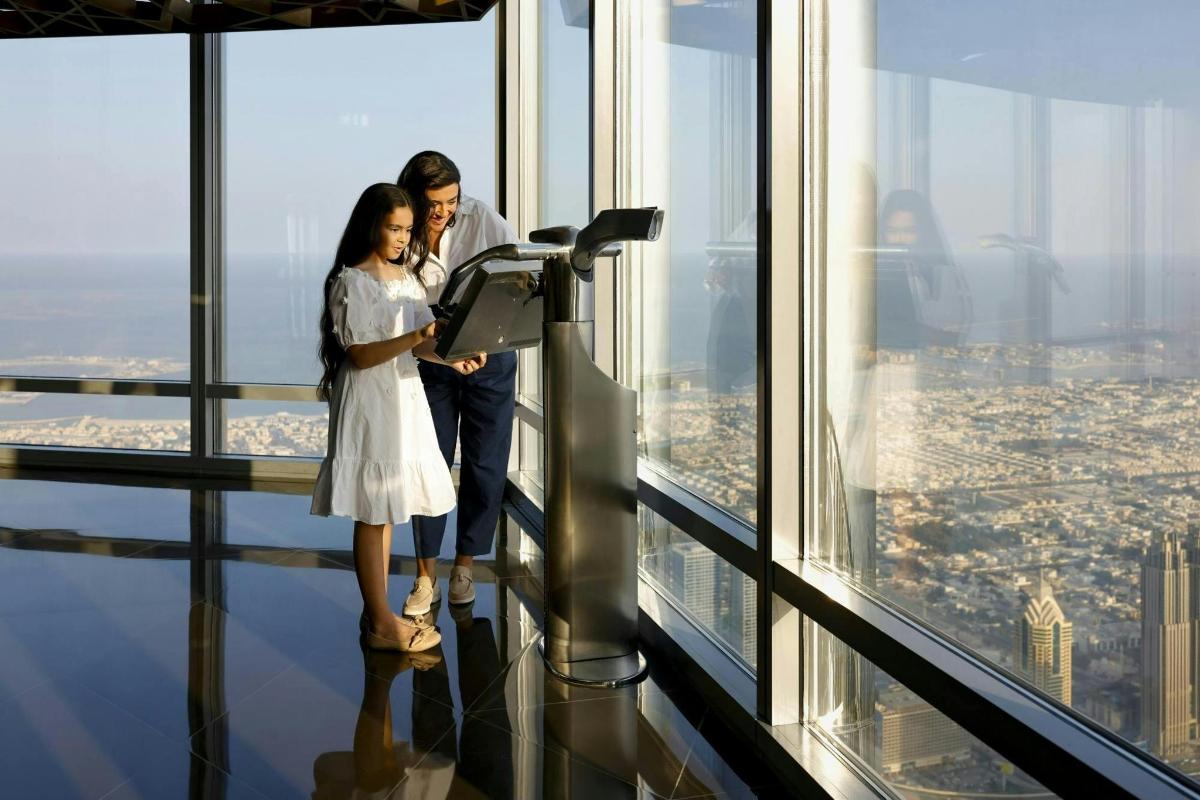 a man and a woman standing on the top of an observation tower