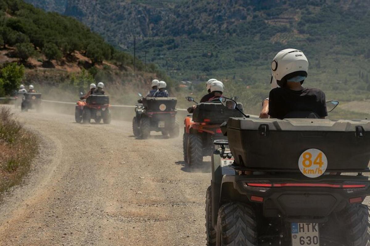 a group of people riding atvs on a dirt road