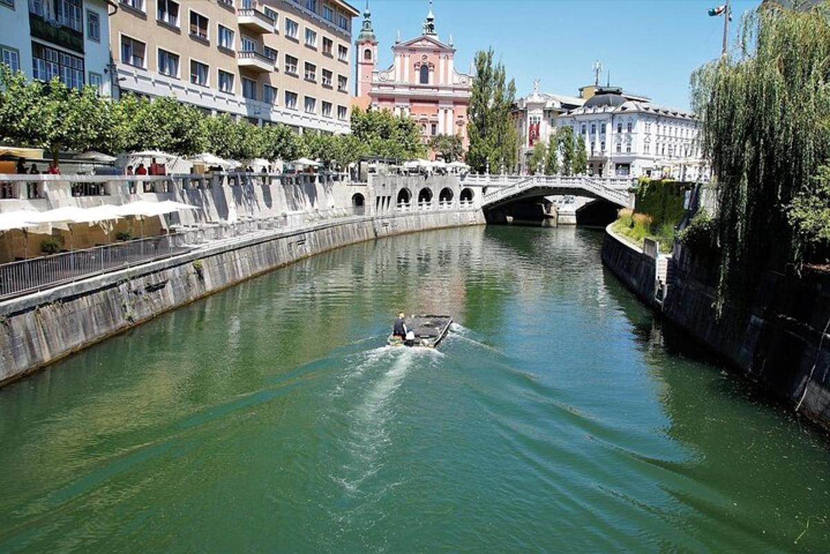 a boat in a river with a bridge