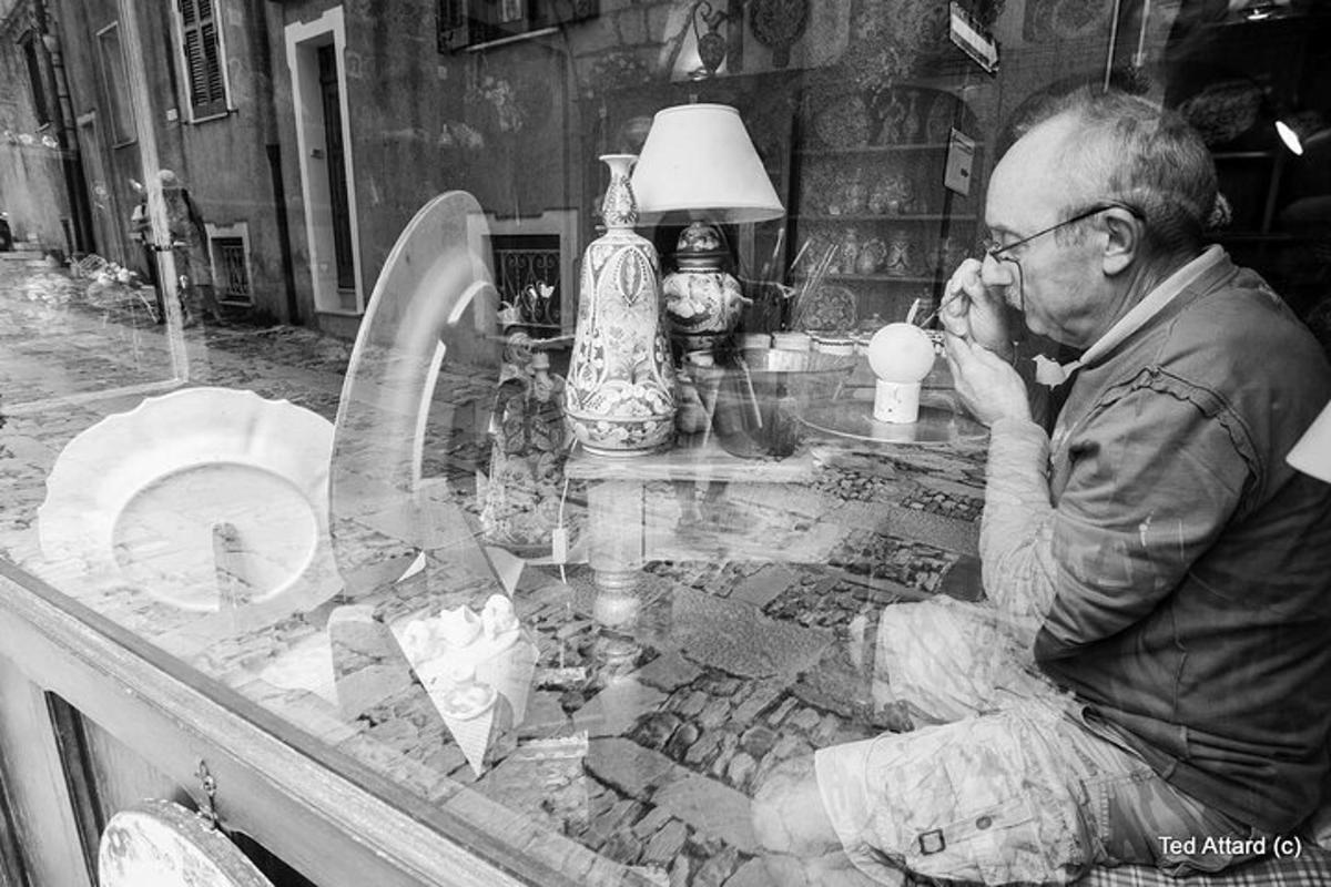a man sitting at a table drinking a coffee