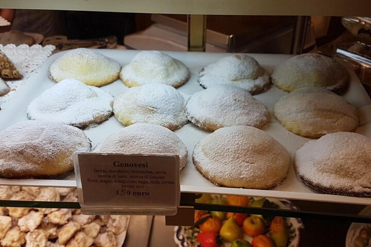 a display case of powdered donuts in a bakery