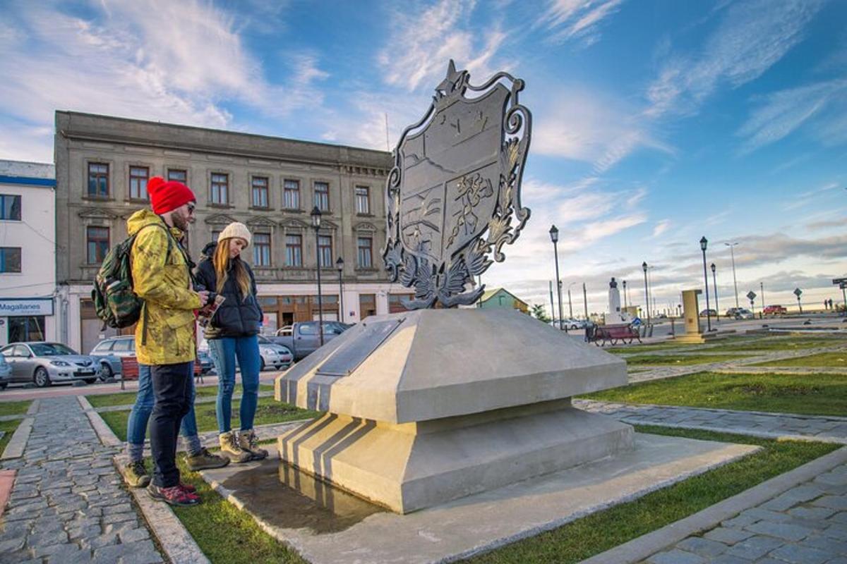 two people standing next to a monument in front of a building