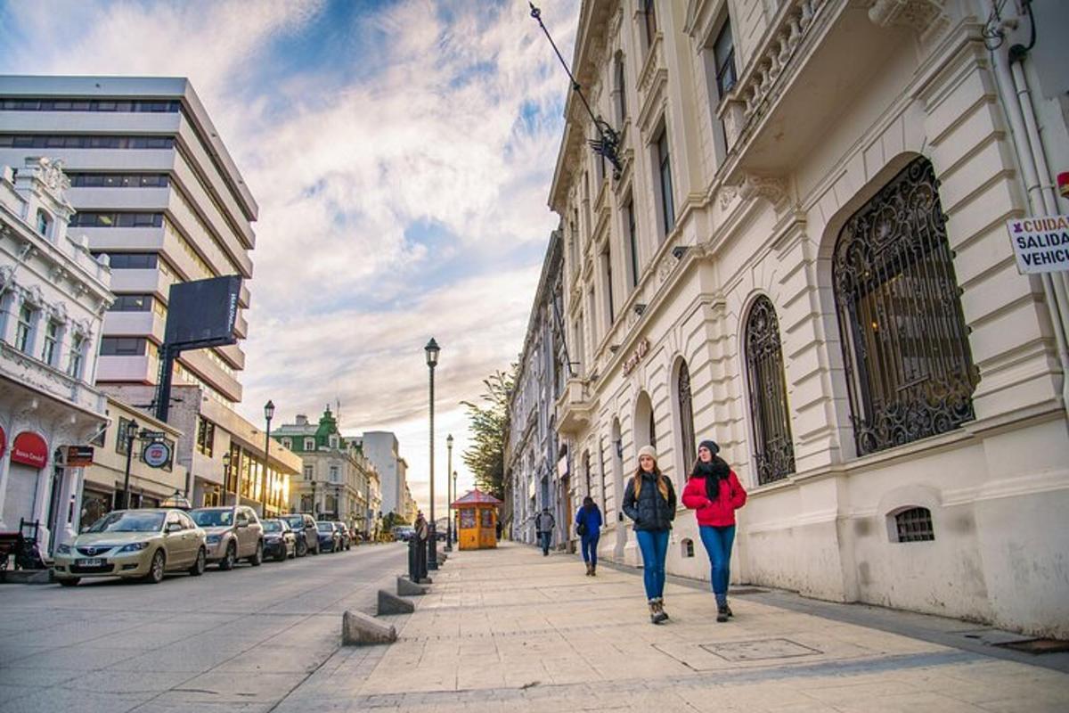 two women walking down a sidewalk on a city street