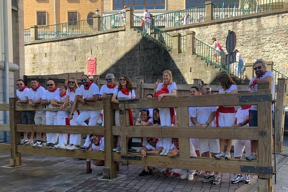 a group of people standing behind a fence