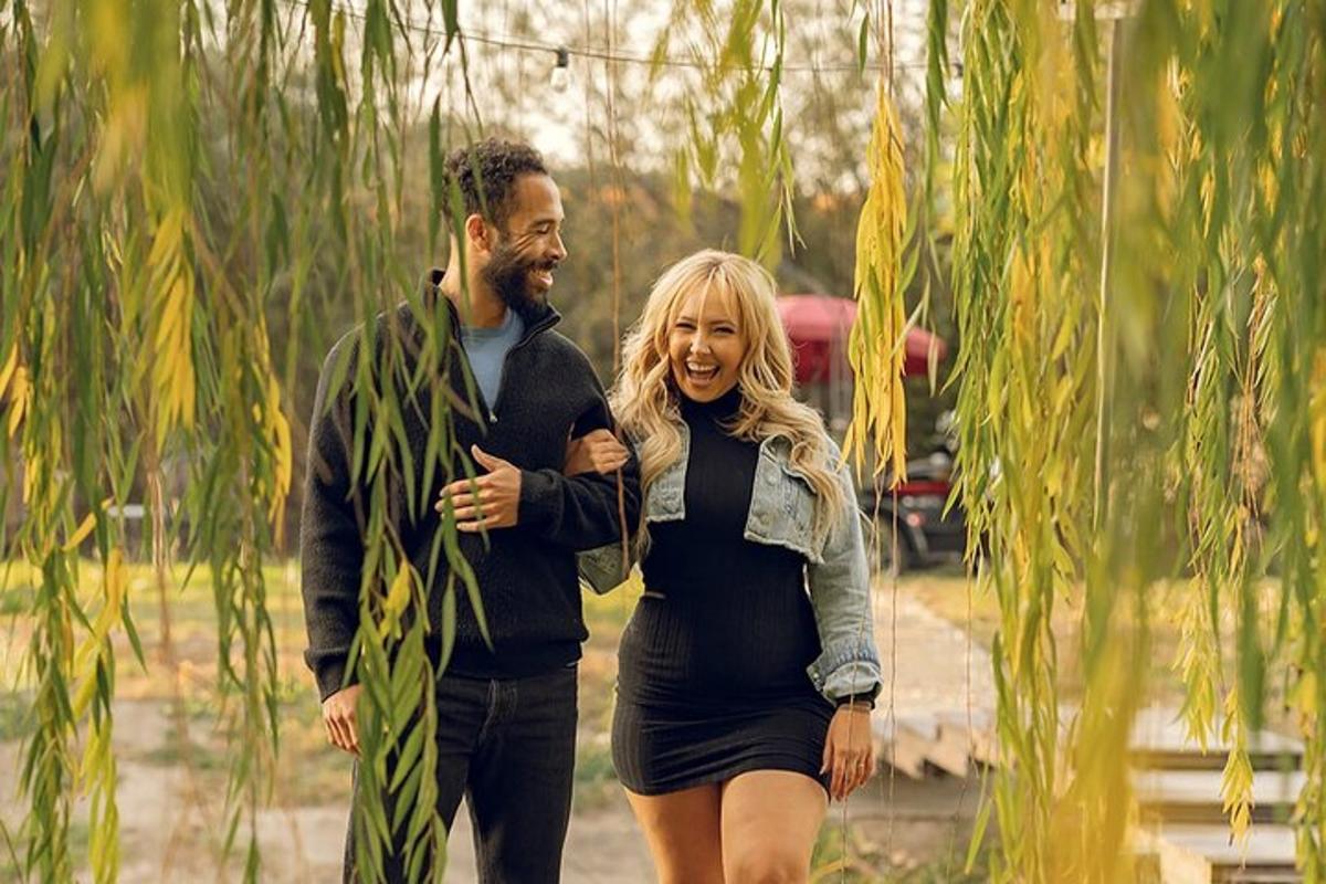 a man and a woman walking in a park