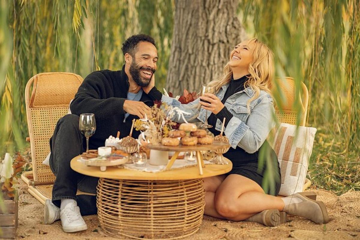 a man and woman sitting at a table with wine glasses