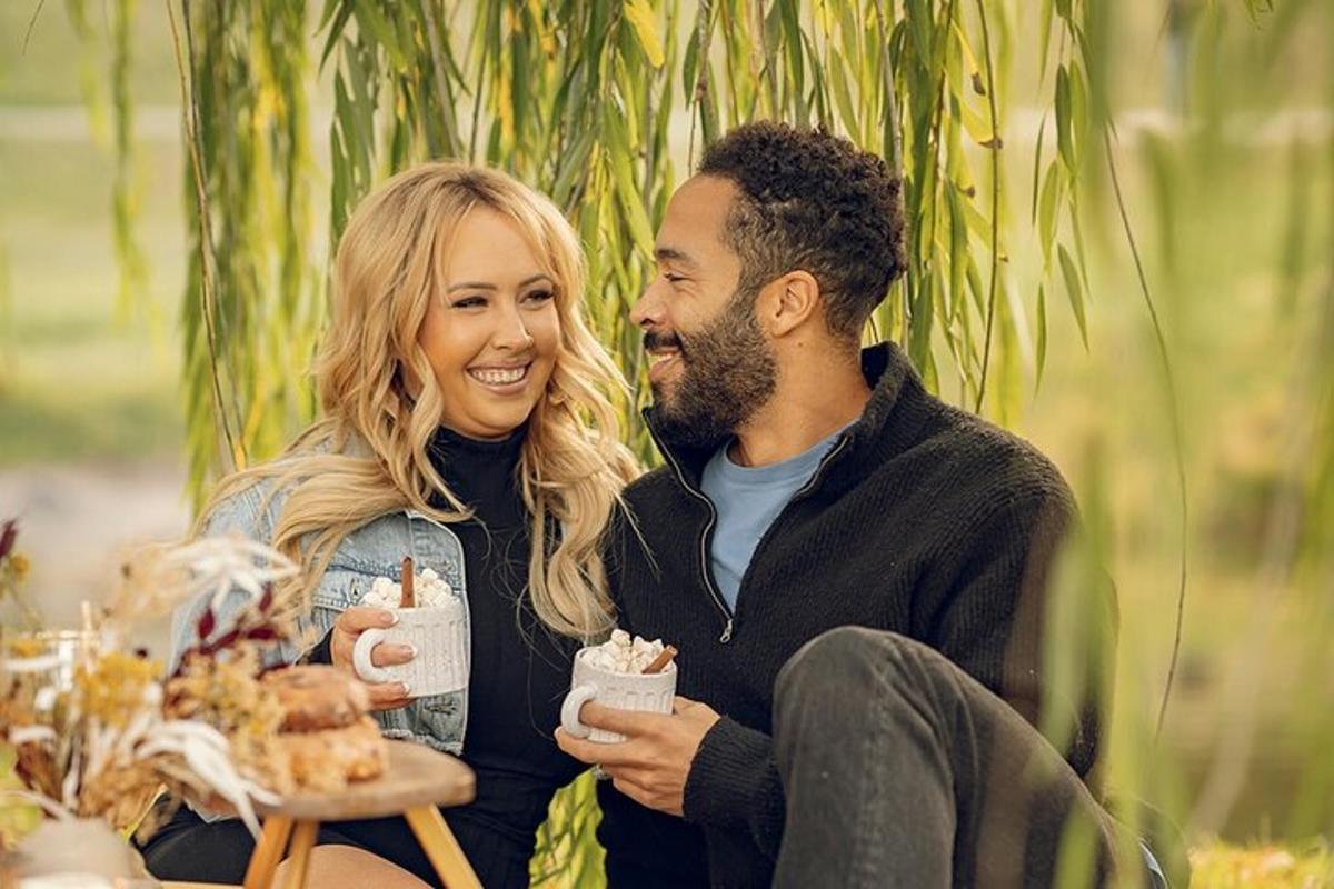 a man and woman sitting next to each other eating food