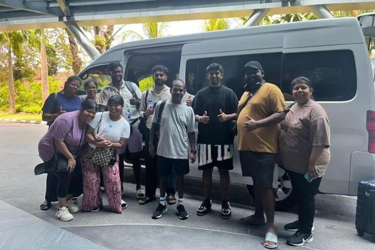 a group of people standing in front of a van